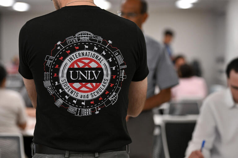student wearing shirt that says unlv international students and schoolars