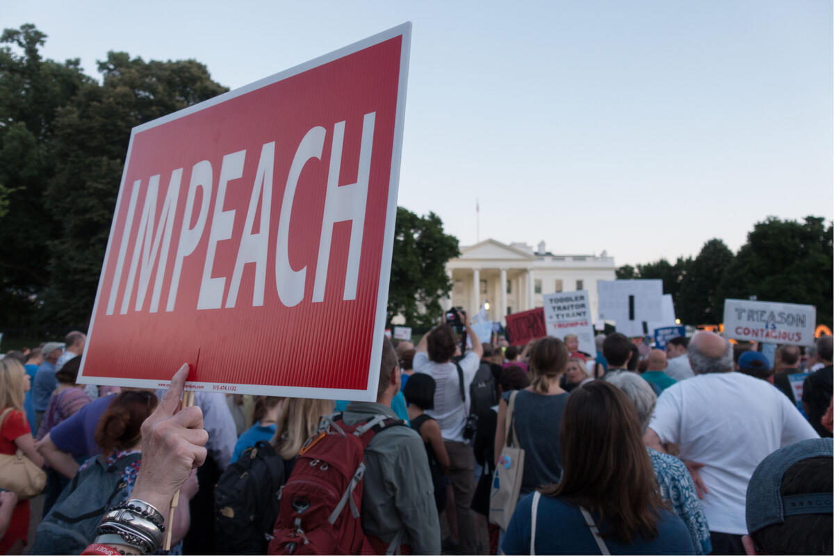 protesters in front of white house holding &quot;impeach&quot; sign