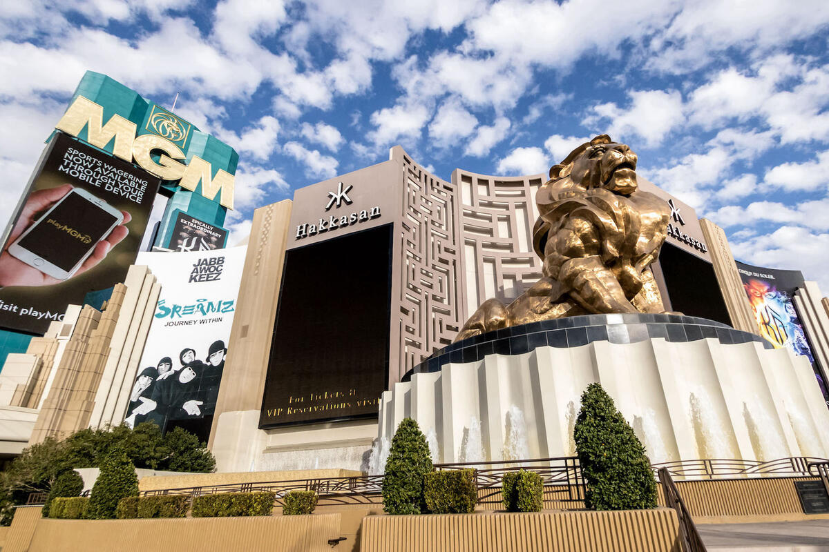 View of MGM casino with a large golden lion sculpture out in front.