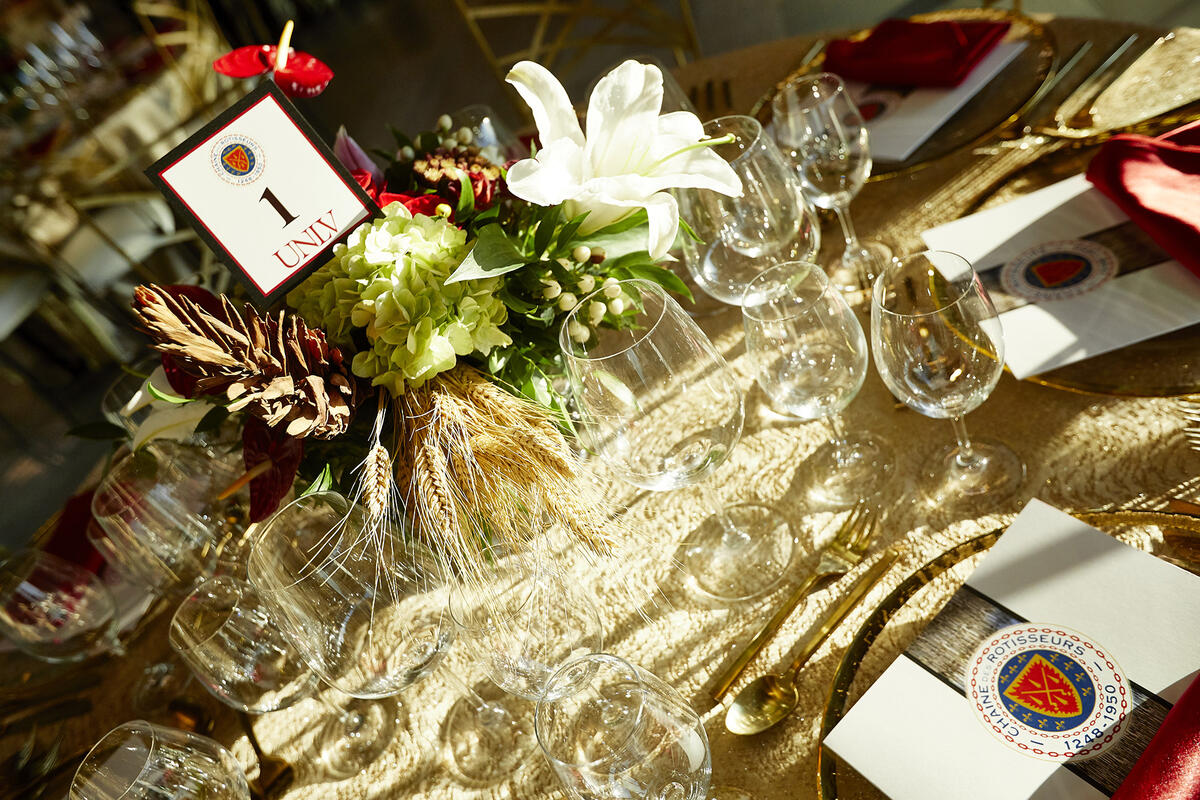 table filled with glasses and a UNLV invitation card