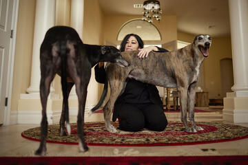 woman with two greyhounds