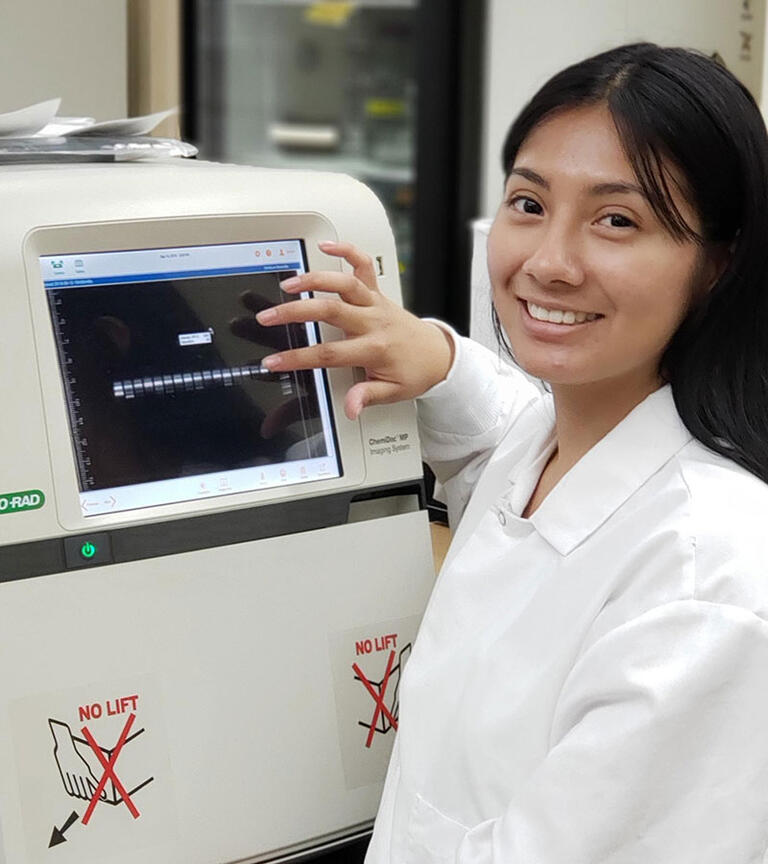 Female student smiling in the lab