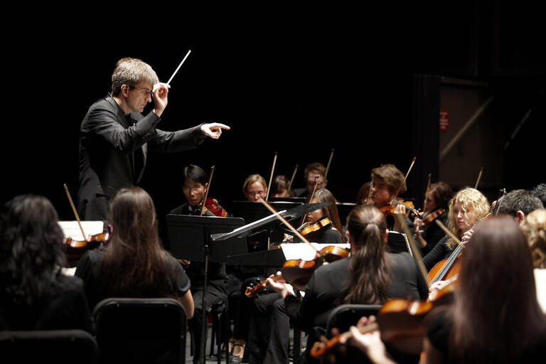 man conducting symphony orchestra