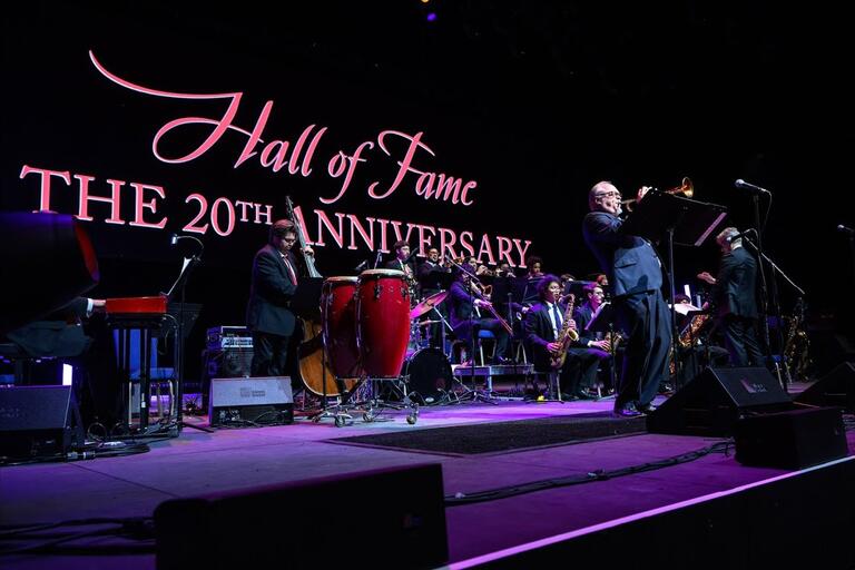 UNLV Jazz on stage at Fountainebleu Las Vegas, behind them the words: Hall of Fame 20th Anniversary