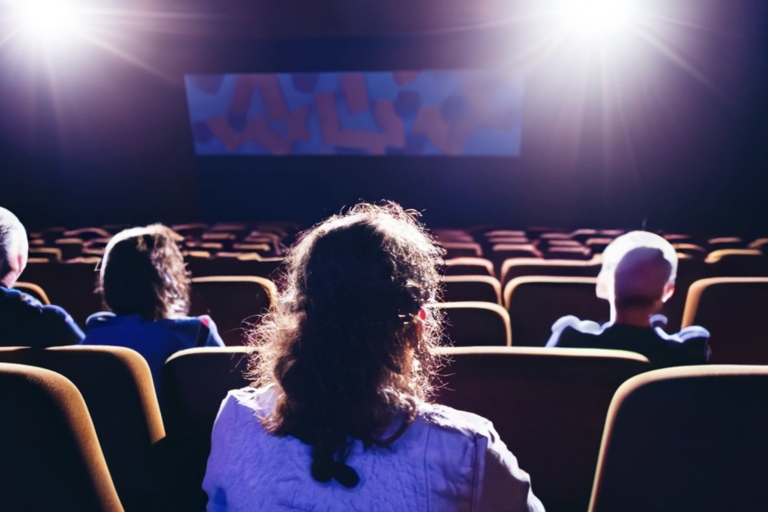 movie goers in a dark movie theater