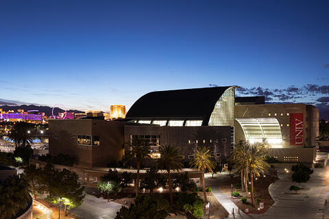 Lied Library in the evening with the Las Vegas Strip glowing in the background.