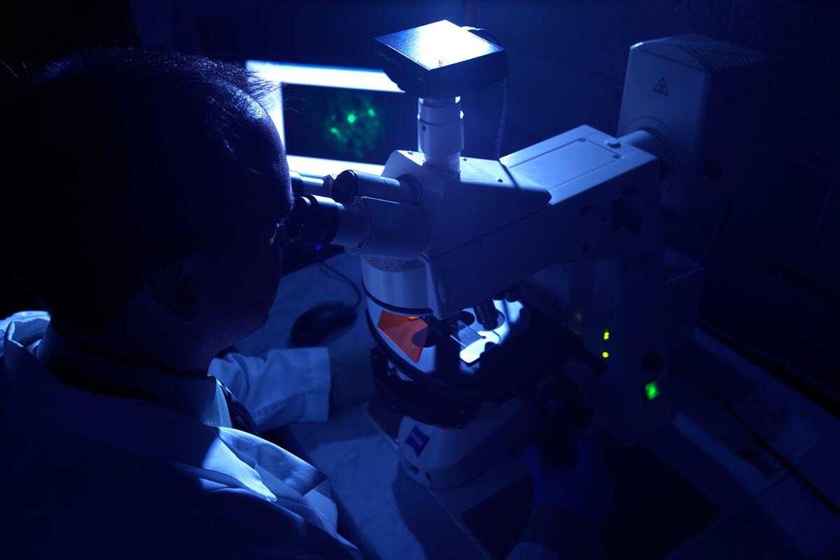 a man looking through a telescope