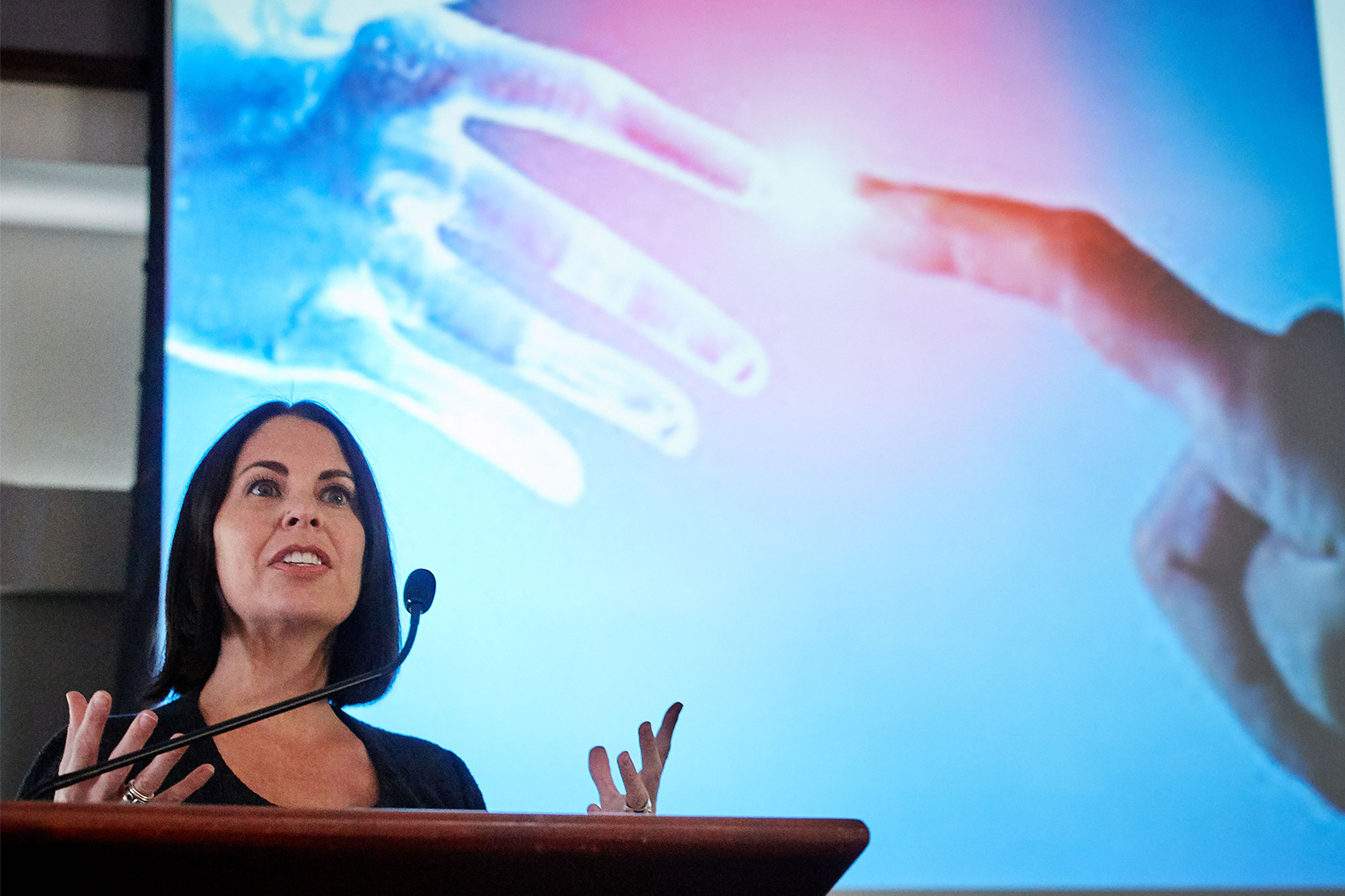 Dr. Anne Weisman talking in front of a podium at the Research Week kickoff event in October 09, 2017