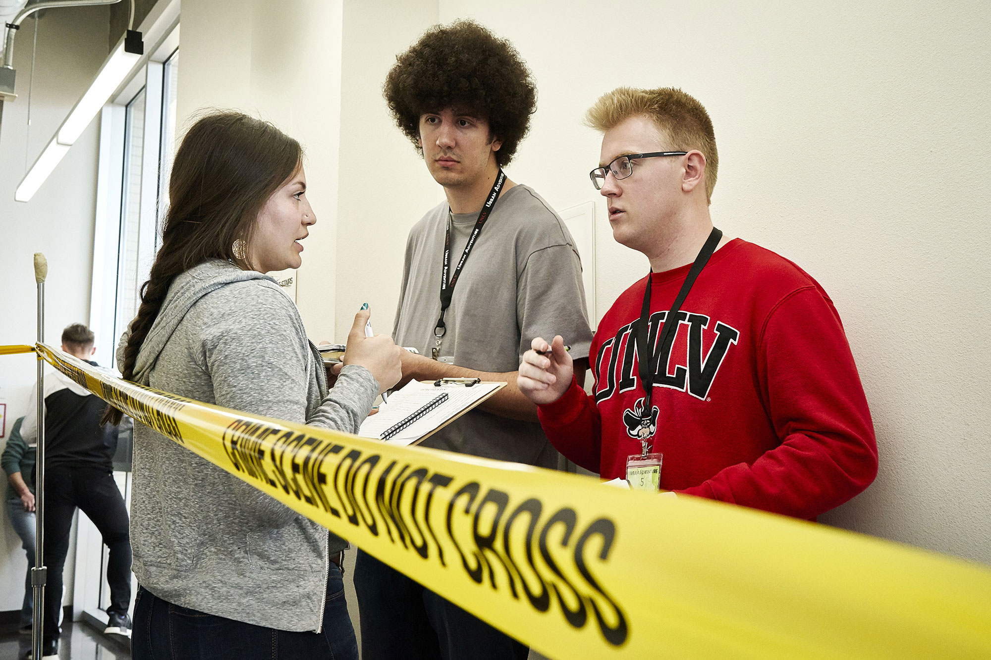 A female and two male students talking