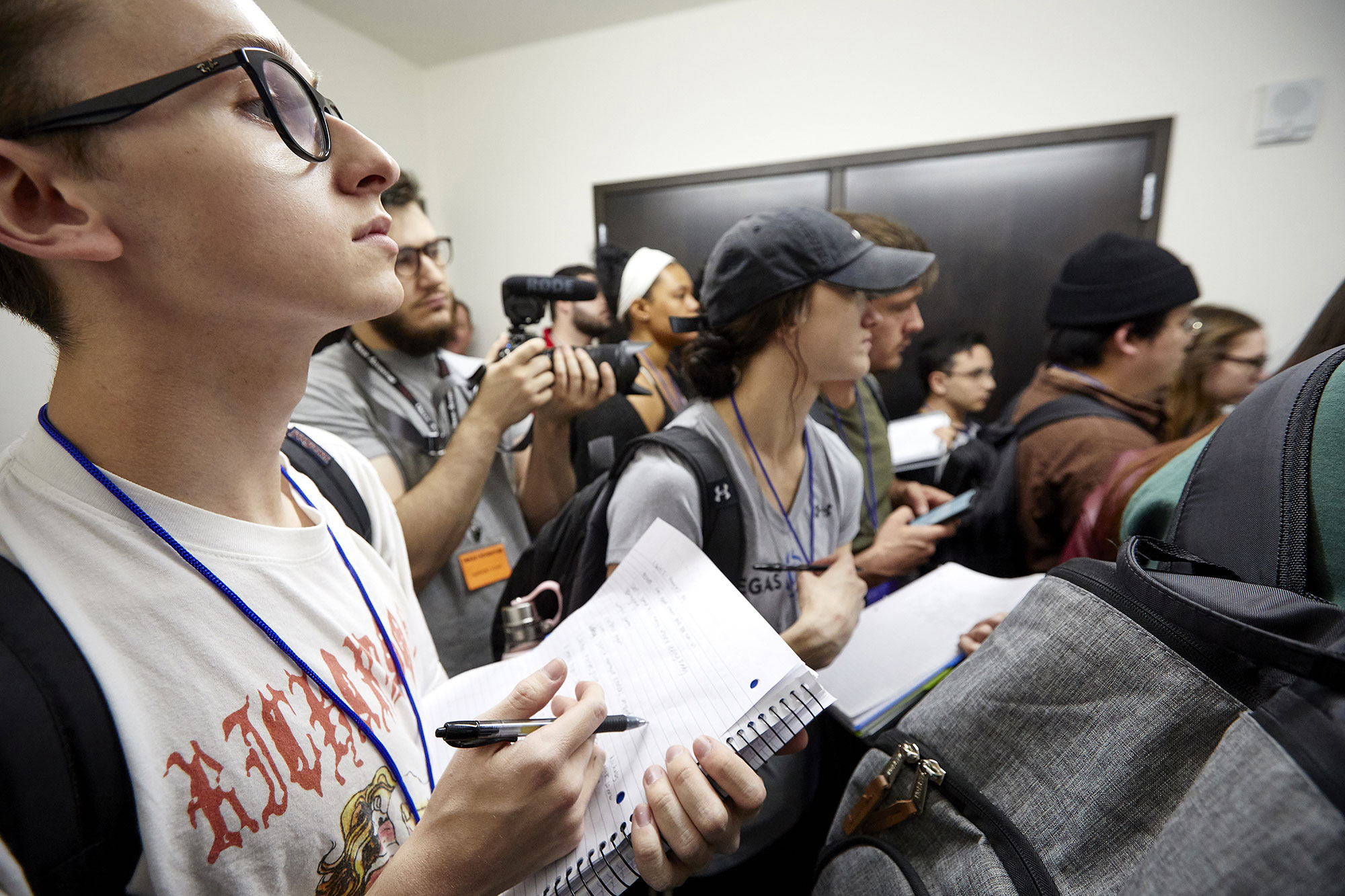 Multiple students taking notes while standing up