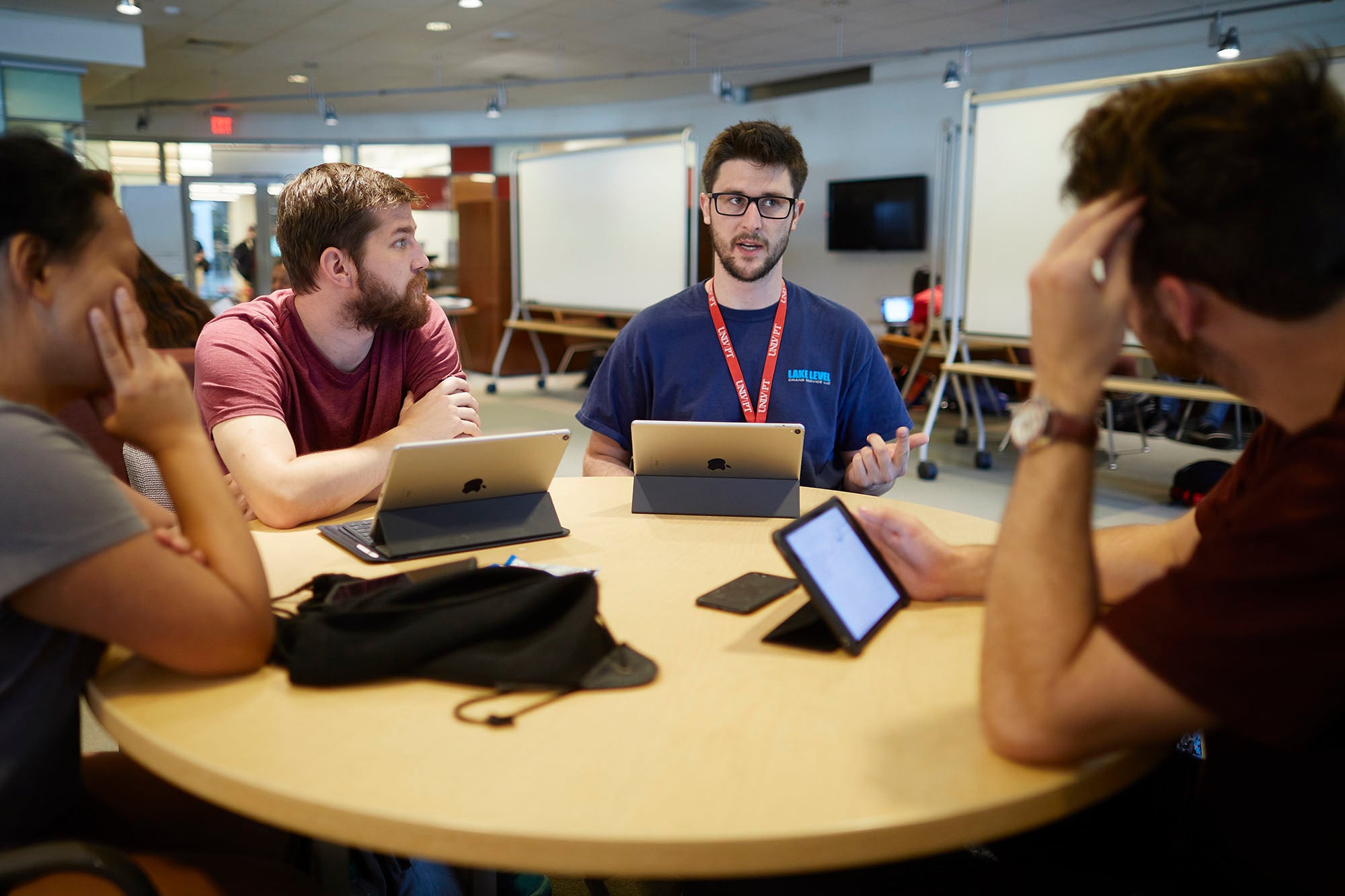 Students at a round table having a discussion.