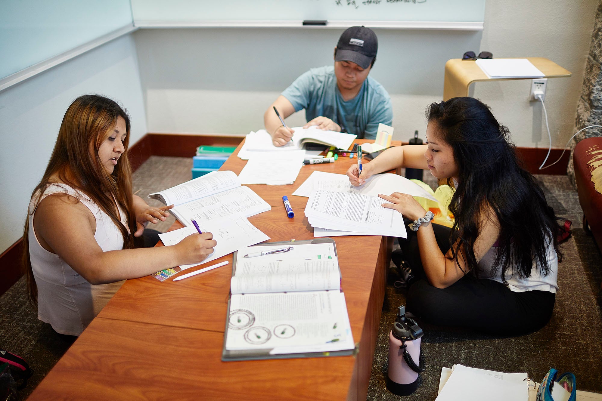 Students in a classroom working on assignments.