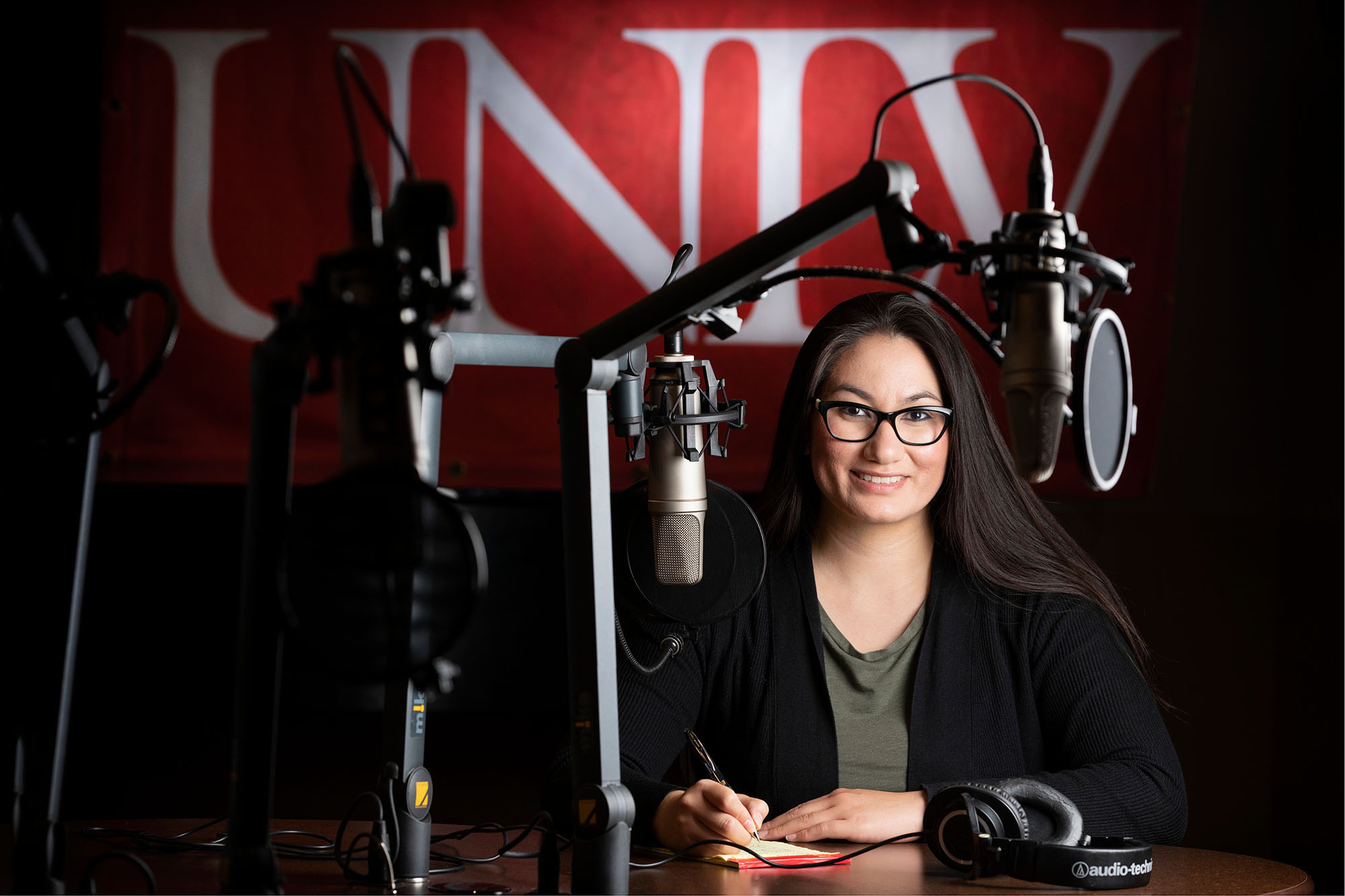 A woman inside of a radio studio.