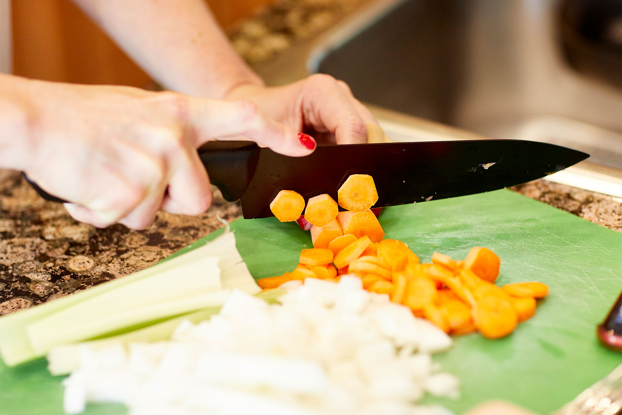 Dr. Anne Weisman cutting vegetables during the Health Meets Food course