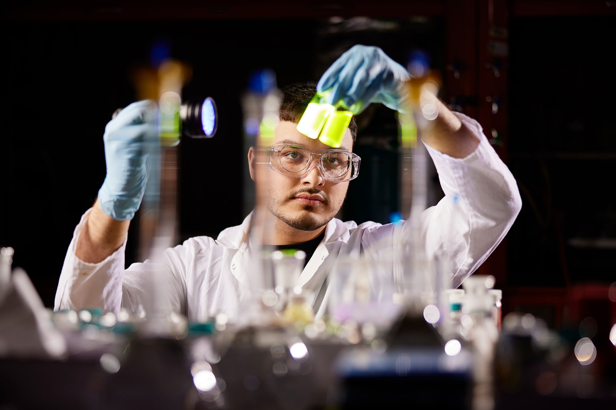 Student holding test tubes to the light