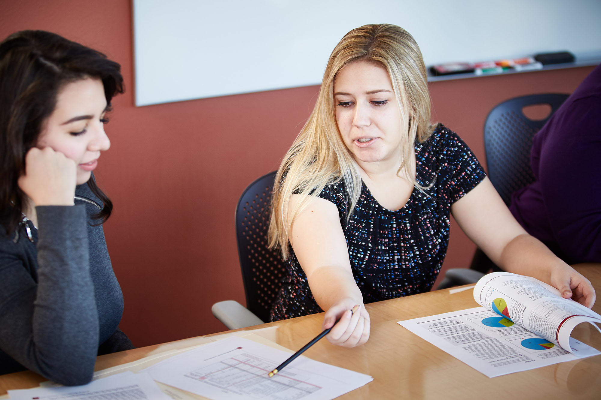 Two women talking while sitting at a table