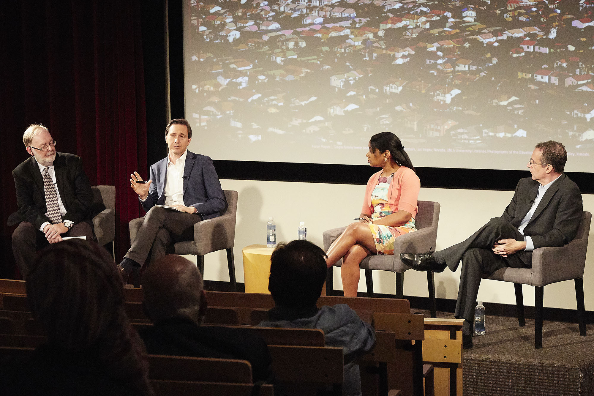 Panel of people talking while seated on stage