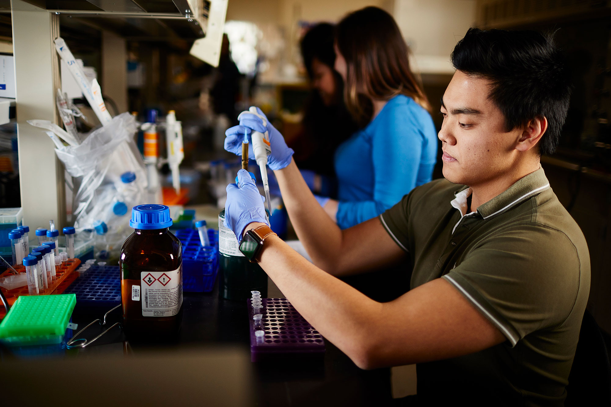 A man ion a lab holding a hand-held torch