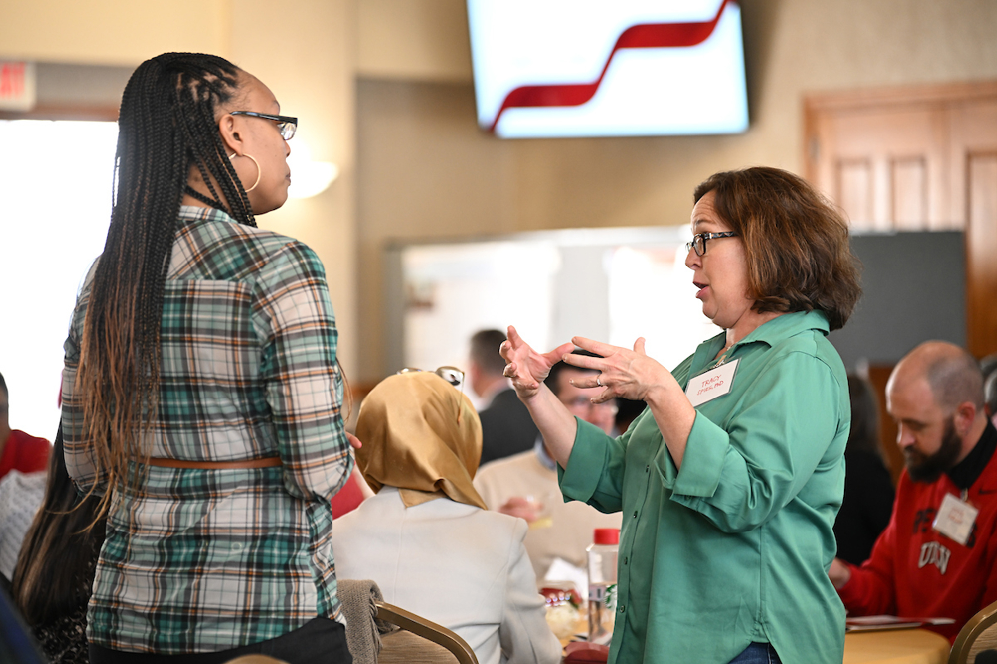 two women speaking to each other