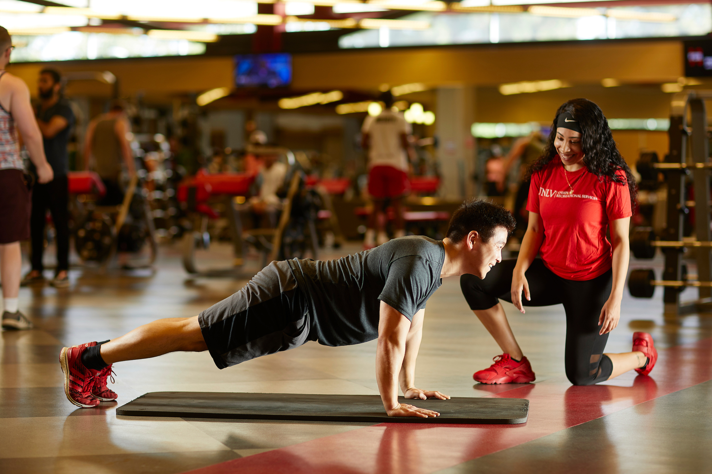 a person at a plank position in a gym