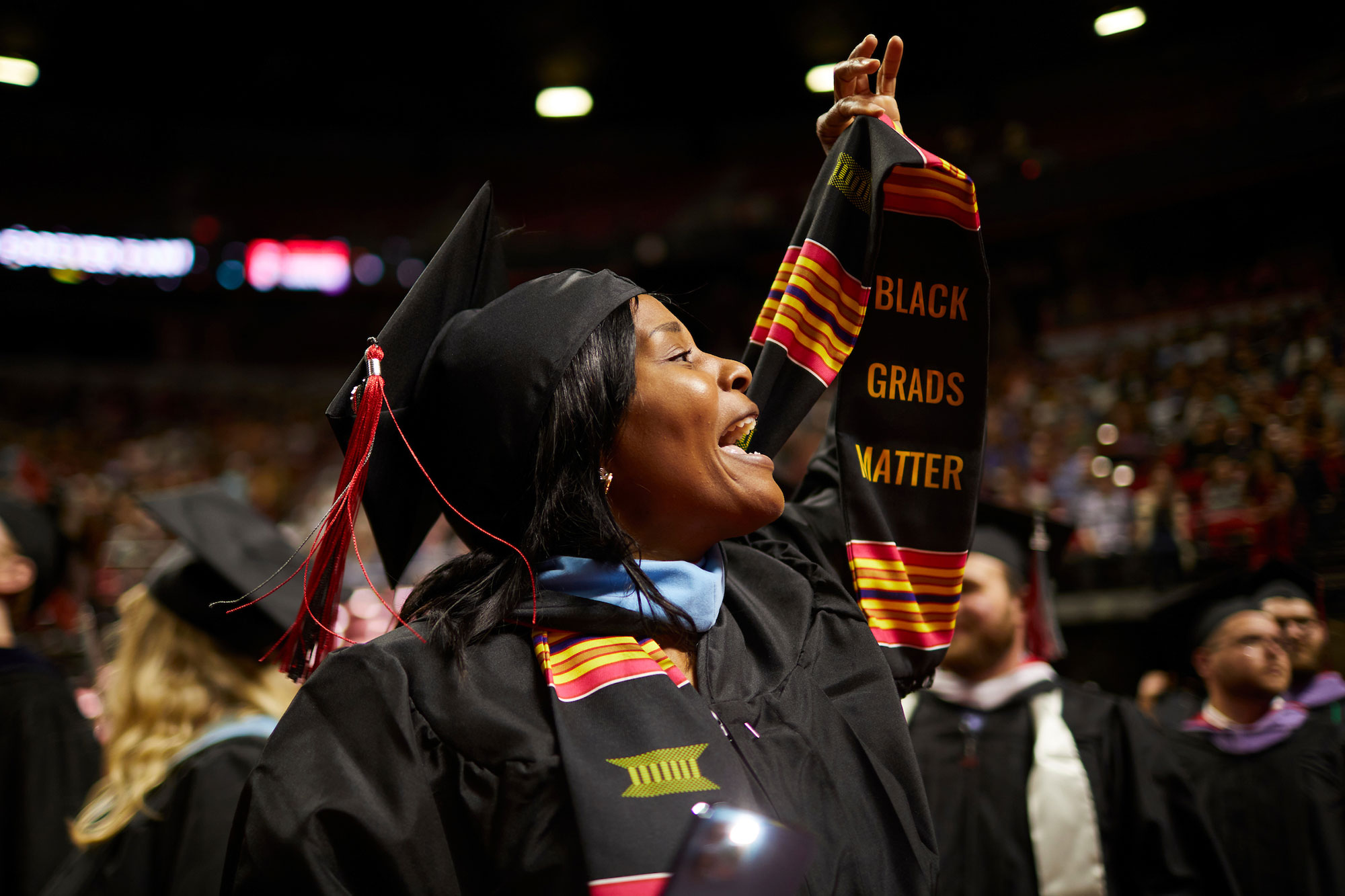 A woman holding up their stole in the air