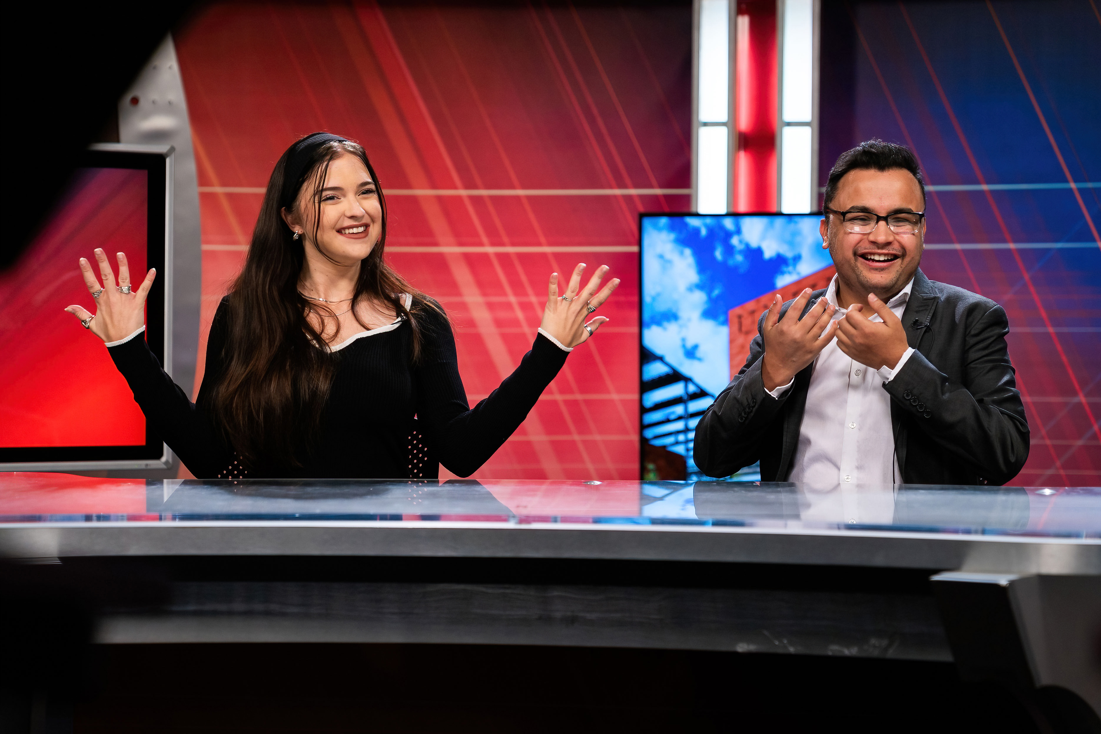 Two students sitting on a news center table