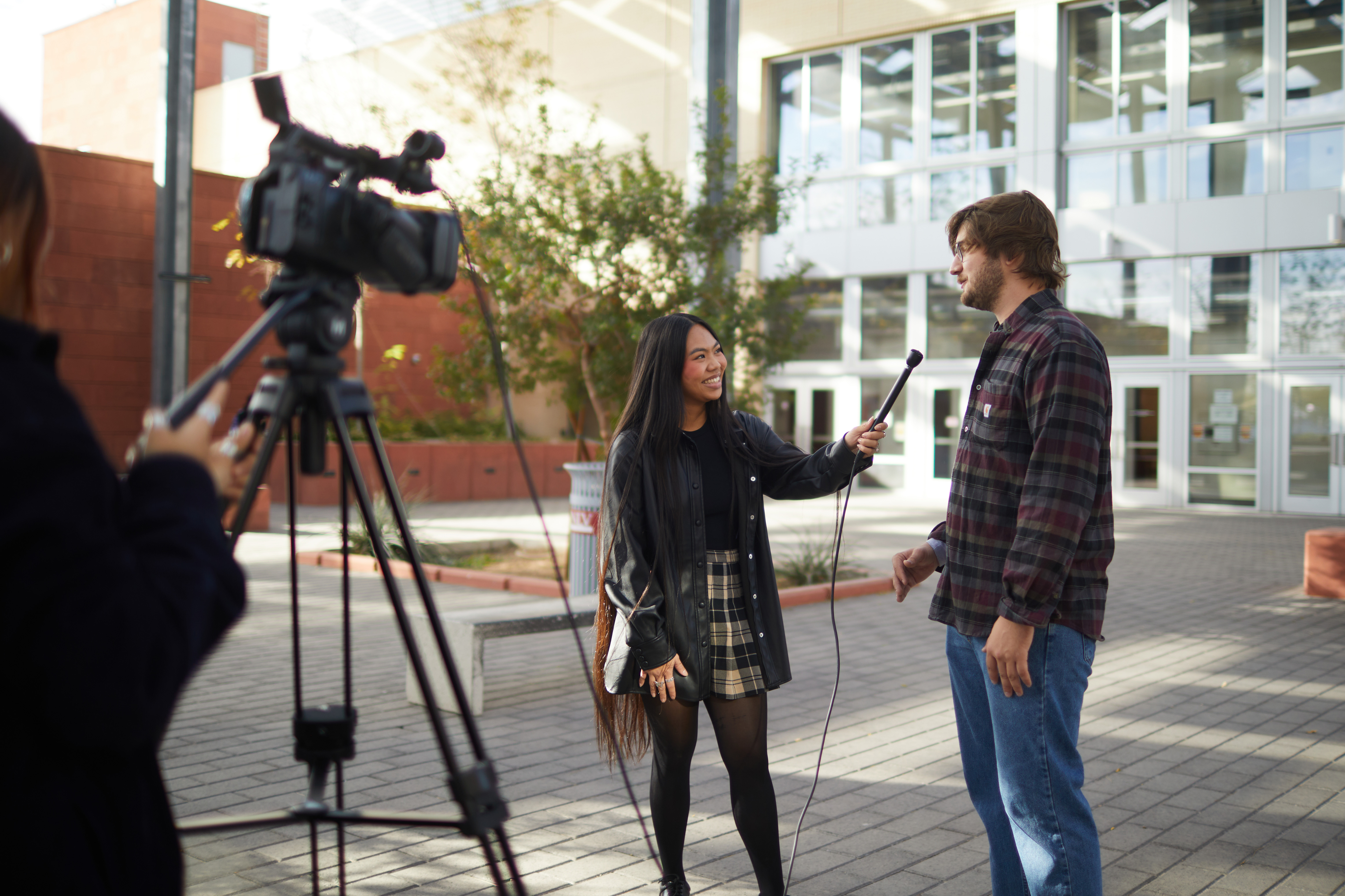 a person interviewing a student in front of a video camera