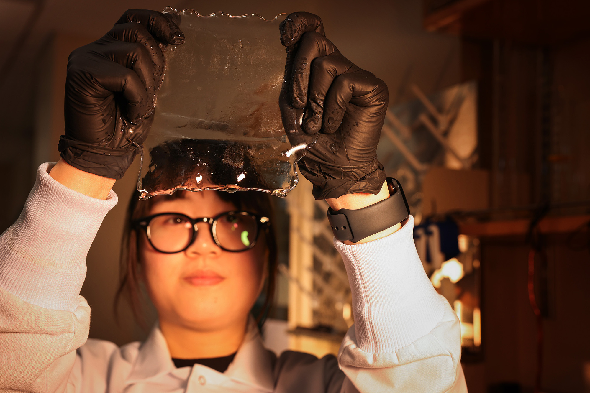 A person holding up a clear plastic like object