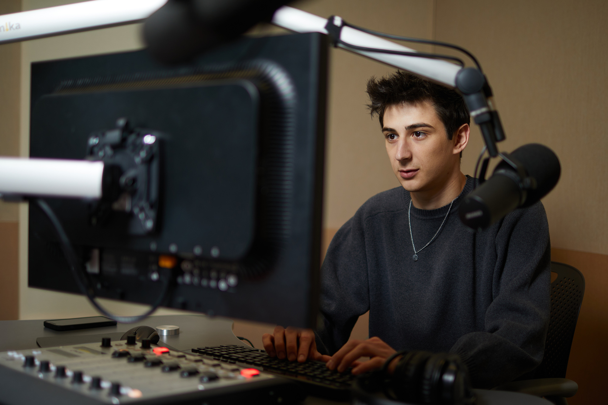 Young man working on a radio producer's station