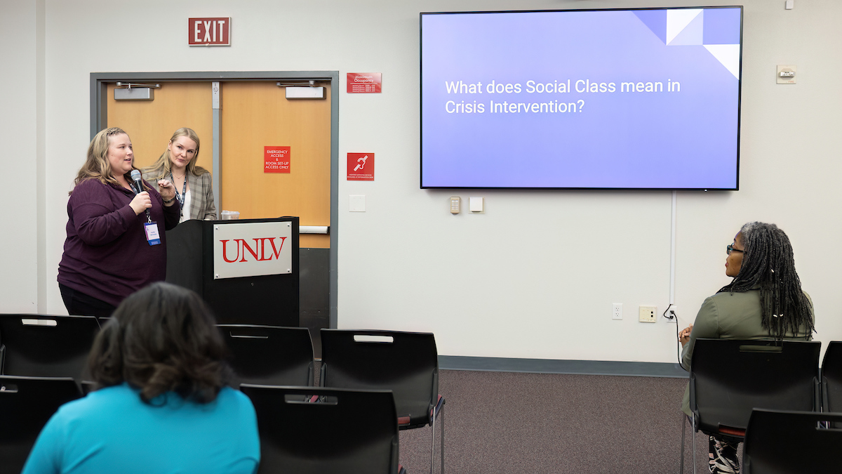 Presenter presenting a slide on &quot;What does Social Class mean in Crisis Intervention?&quot;