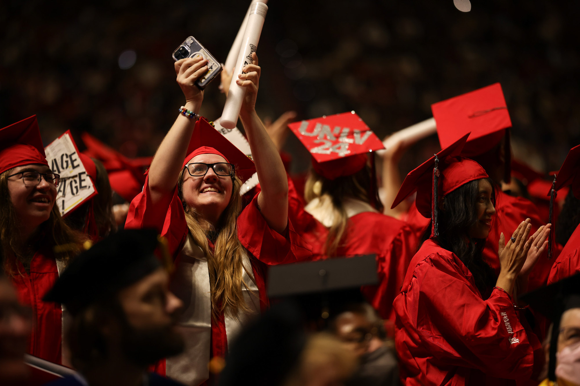 People clapping and cheering at a graduation ceremony
