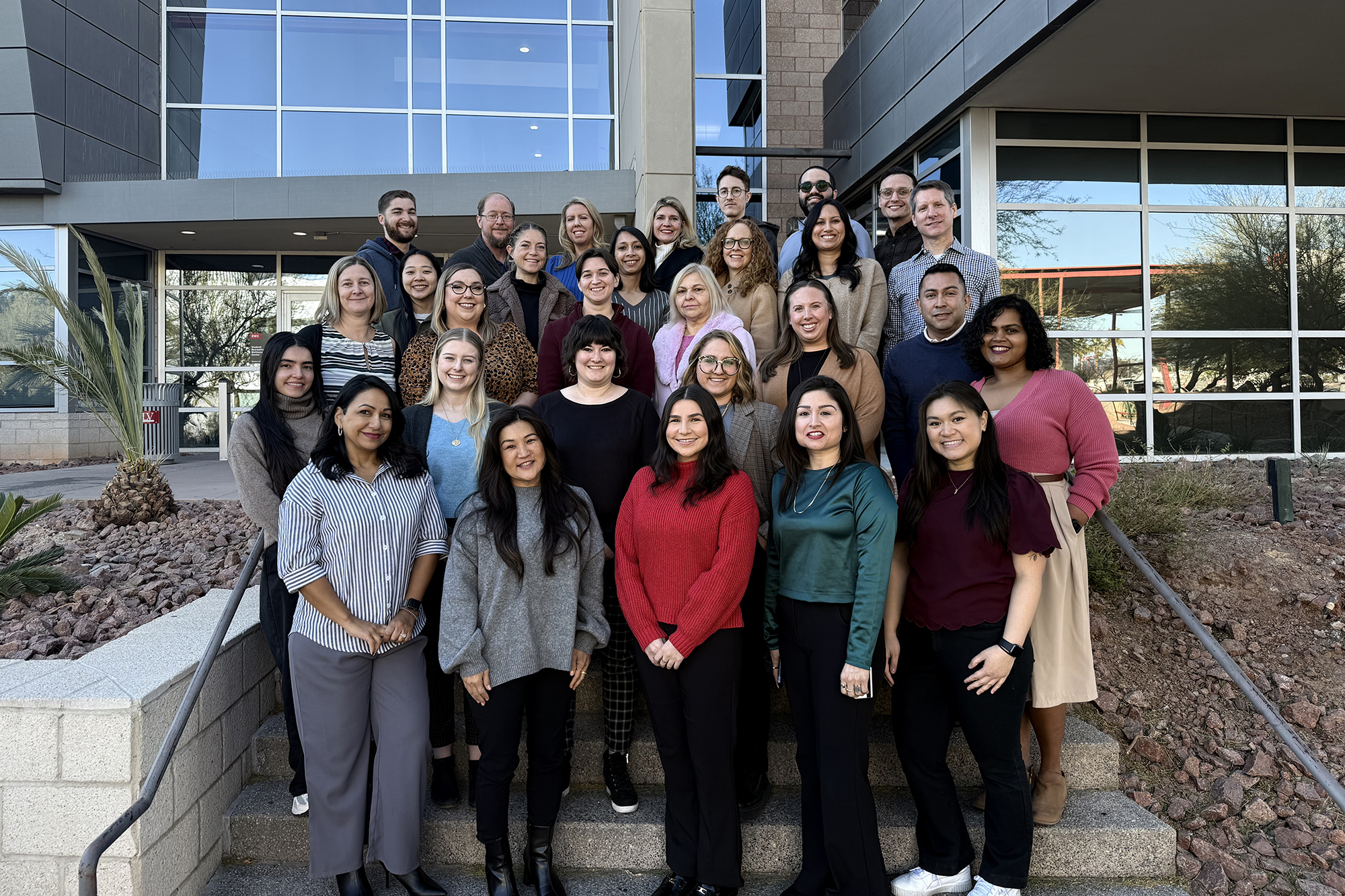 Group photo of CAPS staff outside the Student Wellness and Recreation Center