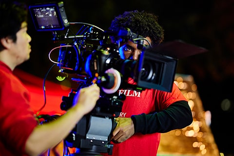 Two students operating a television camera