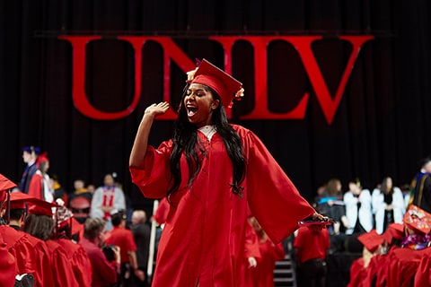 A student celebrates at commencement