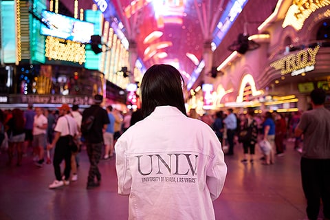 Student in U.N.L.V. jacket at Fremont Street Experience