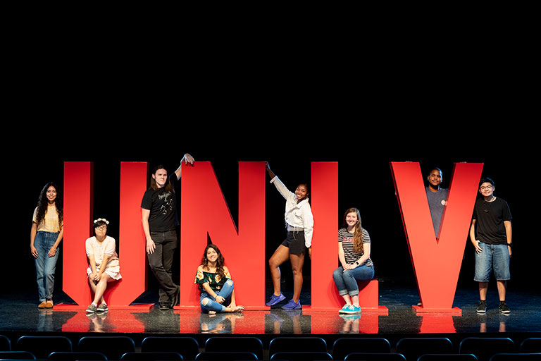 Students posing with large red U-N-L-V letters