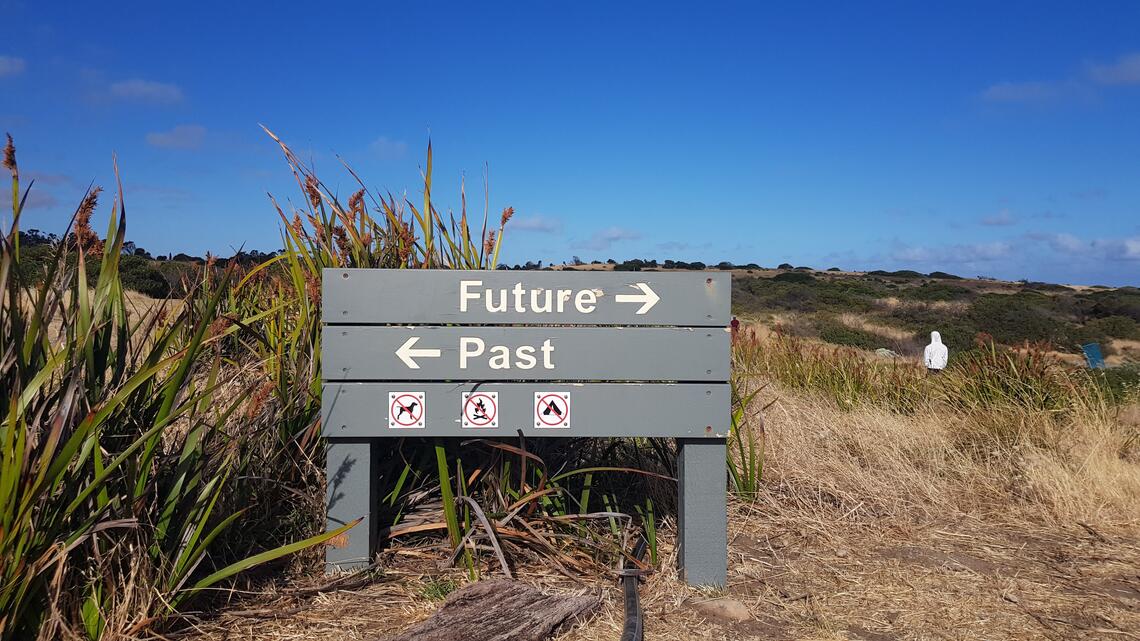 the past, the future road sign