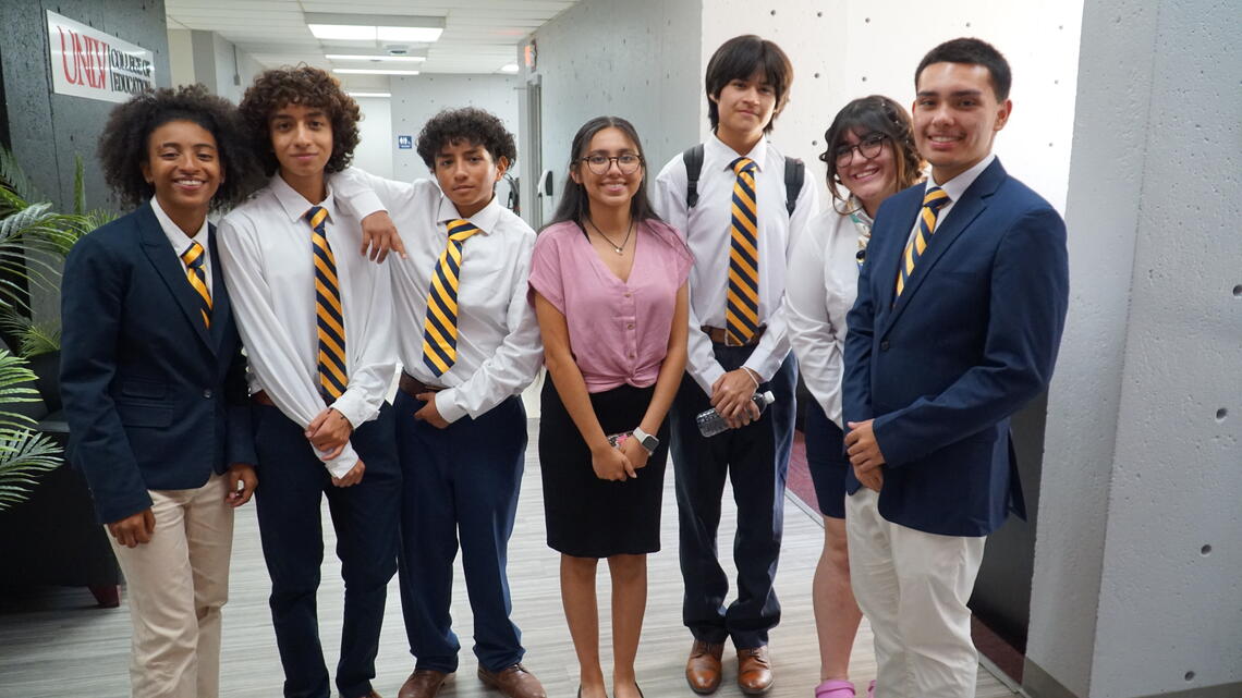 Group of high schoolers standing next to each other smiling