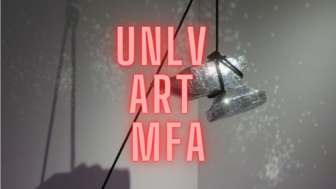 A shiny anvil hanging in an art gallery with the words &quot;UNLV ART MFA&quot;