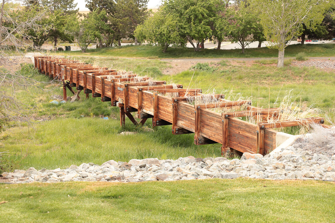 Photo of a wooden Flume over a ditch