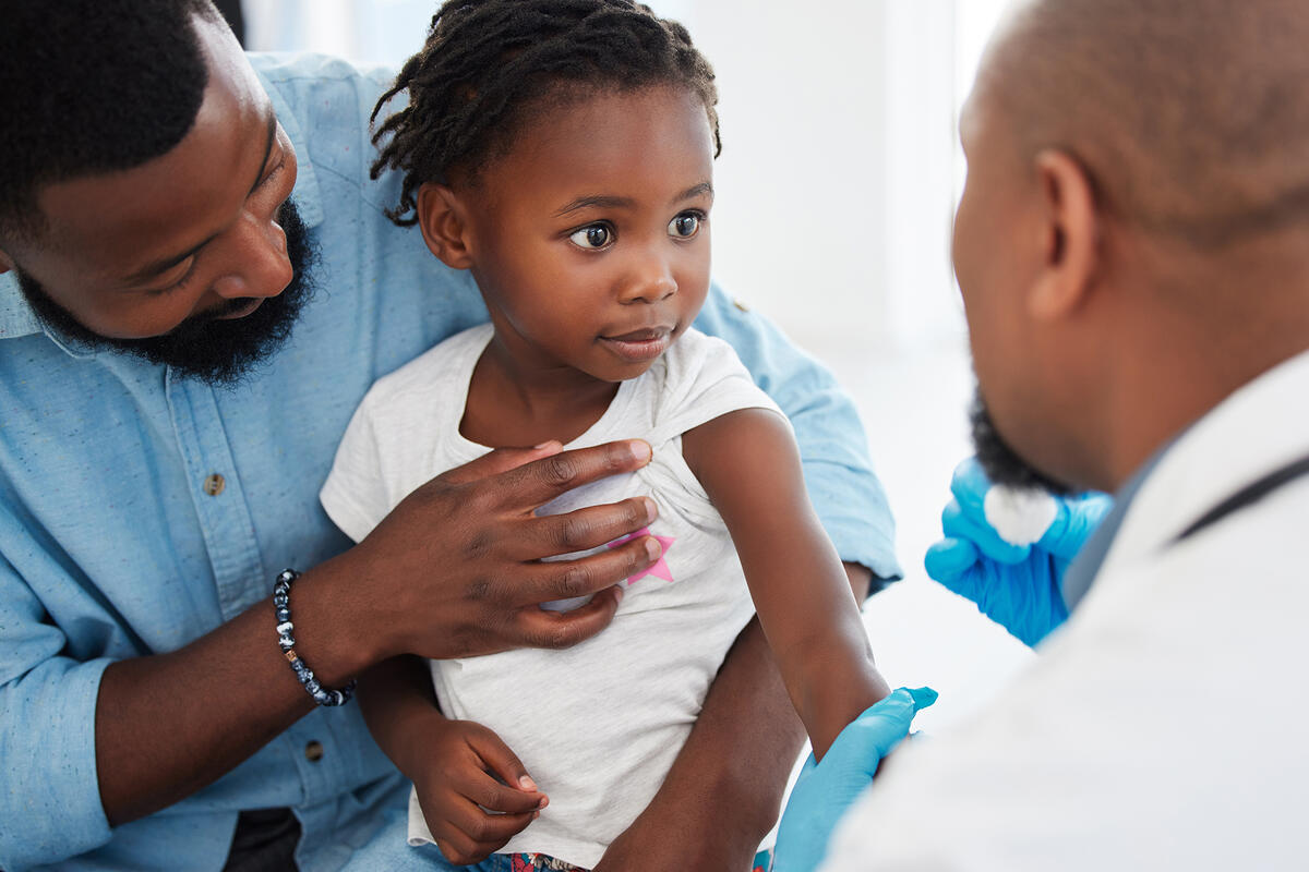 Father and child in a consultation with a pediatrician.