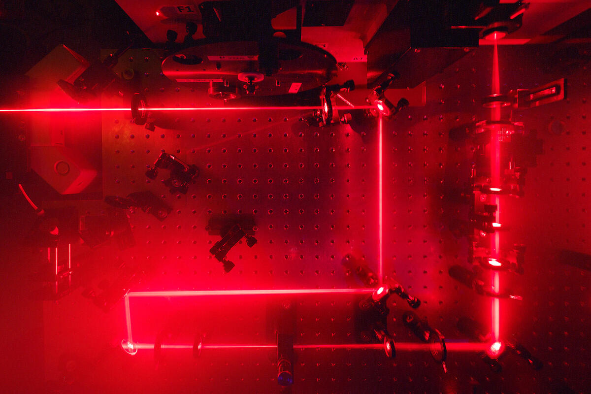 Red laser bouncing of mirrors to form a path of right angles