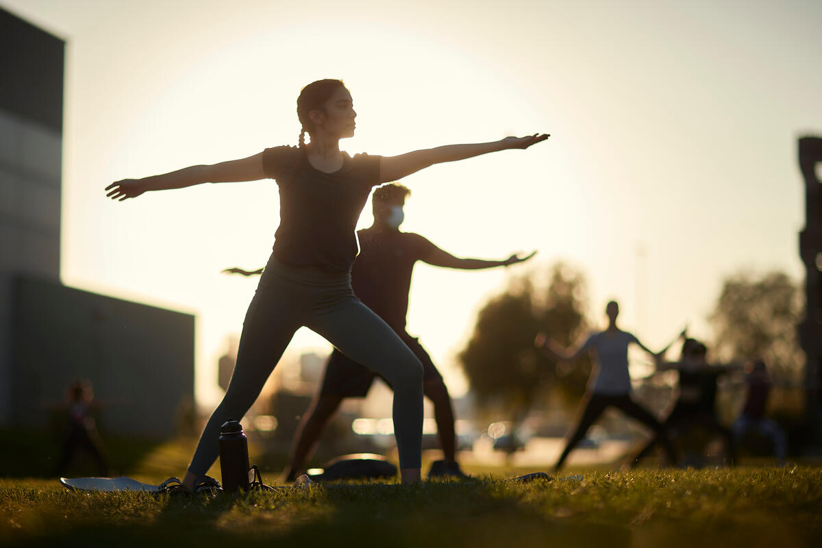 group of people doing the warrior yoga pose