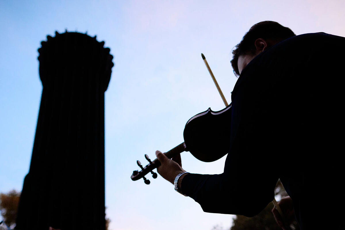 violinist playing in silhouette