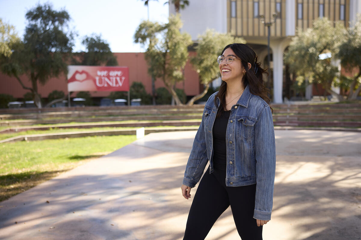 A student walking by the Student Union ampitheater