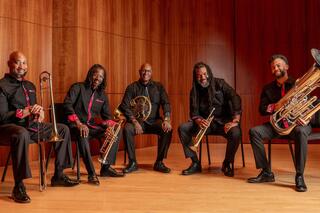 A promotional photo of the Gateways Brass Collective. The artists are holding their instruments.