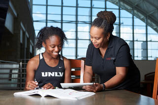 A student swim athlete studying with a UNLV librarian.