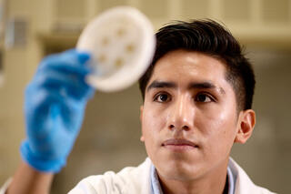 A portrait of Benjy Sedano-Herrera in a lab.