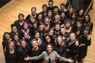 The members of Vox Femina look up towards the camera in this promotional photo.