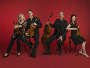 string quartet members with instruments